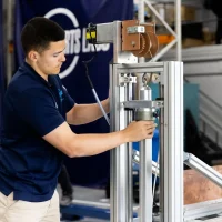 A man does some testing on equipment.