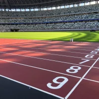 A running track with a large grass section in the middle.